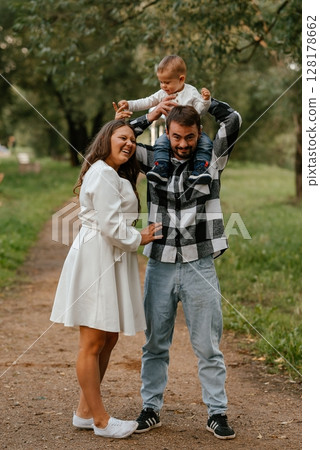 Family Enjoying Outdoor Fun with Toddler on Dad's Shoulders 128178662