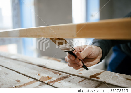 Hand Painting Wooden Surface with Paintbrush 128178715