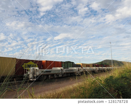 A train stops behind the grass - Stuart Afternoon, LINFOX and a white tank 128178728