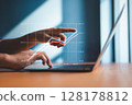 Businessman analyzing financial growth on virtual chart using laptop 128178812