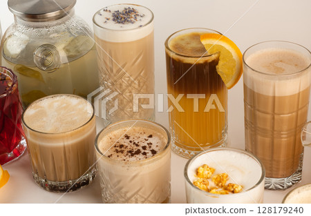 A collection of cozy autumn beverages with spices, popcorn, and fruit, showcasing coffee and tea varieties 128179240