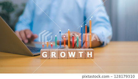 Business growth and financial success concept with person arranging growth cubes and glowing upward bar chart 128179310
