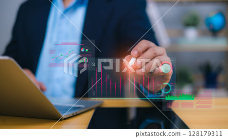 Business analytics and financial data visualization concept with person interacting with holographic charts 128179311