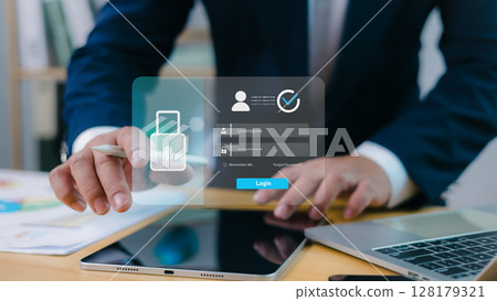 Businessman using virtual login interface on digital device, cybersecurity, data protection, identity verification, and secure online access in modern business environment. 128179321