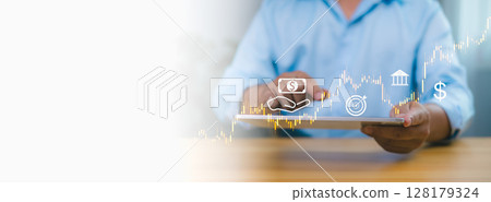 Person in blue shirt using tablet with digital stock market graph, financial icons, symbolizing online investment, digital banking, financial technology, and economic growth on white background. Person in blue shirt using tablet with digital stock market graph, financial icons, symbolizing online investment, digital banking, financial technology, and economic growth on white background. 128179324