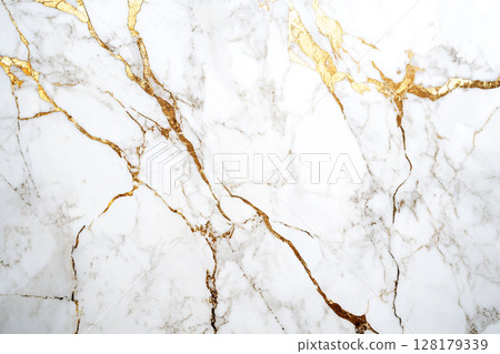 A luxurious white marble surface intricately veined with striking gold and subtle brown patterns, creating an elegant and opulent abstract background. 128179339