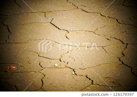 The cracked bottom of a lake that has dried up due to lack of water The cracked bottom of a lake that has dried up due to lack of water 128179397