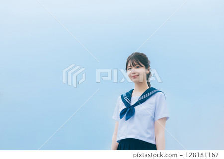 High school girl with blue sky background High school girl with blue sky background 128181162