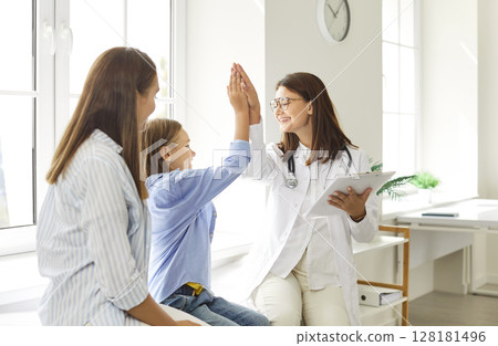 Doctor Giving High Five To Boy At Medical Consultation With Mother Doctor Giving High Five To Boy At Medical Consultation With Mother 128181496