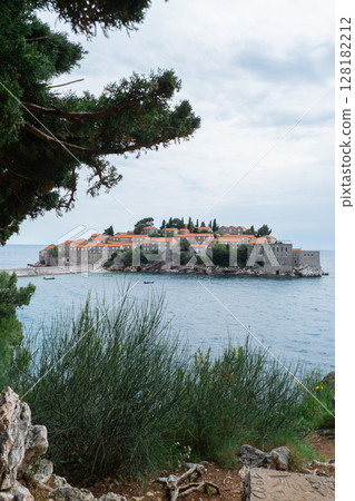 Sveti Stefan private island in Montenegro near Budva. Adriatic Sea Coast travel destination vacation holiday idea. Concept of getting away tourism experiences. Nature driven scenery 128182212