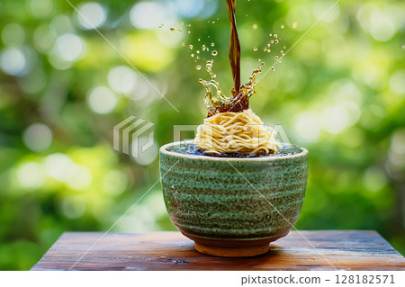 A refreshing summer scene | Close-up of the moment when the noodle soup is poured onto somen noodles A refreshing summer scene | Close-up of the moment when the noodle soup is poured onto somen noodles 128182571