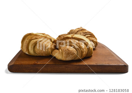 Freshly baked croissants on a wooden tray isolated over a white background 128183058