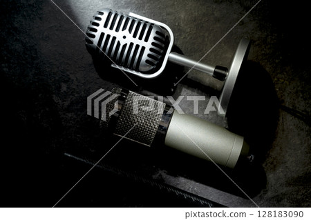 Set of Studio and vintage silver microphones for podcasting or streaming with a black background. Top view 128183090