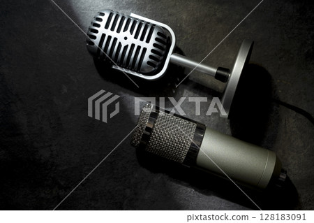 Studio and vintage silver microphone for podcasting or streaming with a black background. Top view 128183091