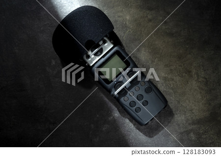 Handy recorder device on a black background. Top view 128183093