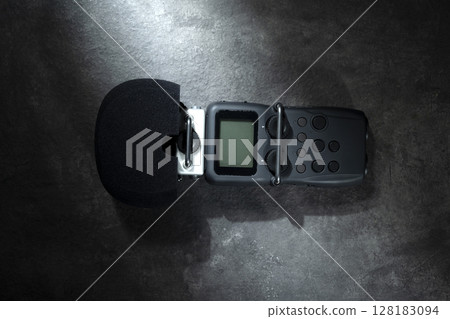 Handy recorder device on a black background. Top view 128183094