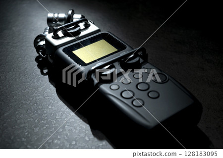 Handy recorder device on a black background 128183095