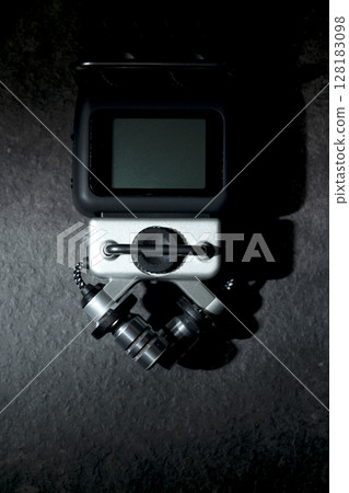 Handy recorder device on a black background. Top view Handy recorder device on a black background. Top view 128183098