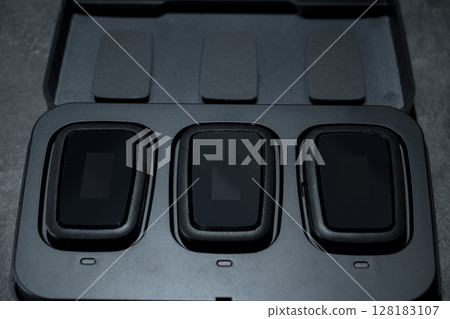 Clip on wireless microphone for interview or podcast equipment in the box on a black background 128183107