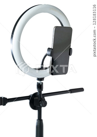 Round LED ring light with a cellphone on a phone holder isolated over a white background. Vlogging or live streaming equipment. Mockup or Copy space Round LED ring light with a cellphone on a phone holder isolated over a white background. Vlogging or live streaming equipment. Mockup or Copy space 128183116