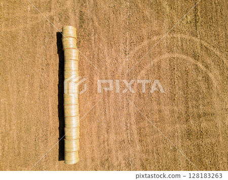 Aerial View of Hay Bales Aligned in a Field After Harvest Aerial View of Hay Bales Aligned in a Field After Harvest 128183263