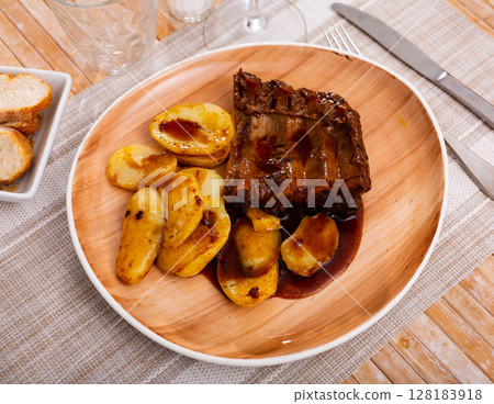 Grilled ribs with potatoes and barbecue sauce Grilled ribs with potatoes and barbecue sauce 128183918