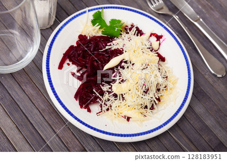 Healthy dish beetroot salad with fresh cheese, parsley and cream sauce on white plate Healthy dish beetroot salad with fresh cheese, parsley and cream sauce on white plate 128183951
