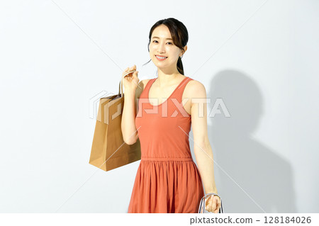 Shopping image of a young woman with a paper bag Shopping image of a young woman with a paper bag 128184026