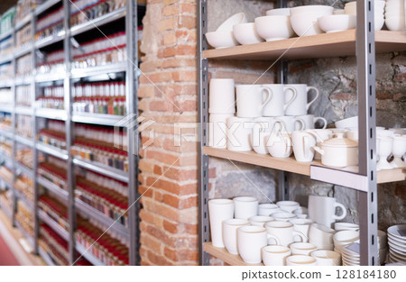 Pottery stands on wooden rack in pottery shop Pottery stands on wooden rack in pottery shop 128184180