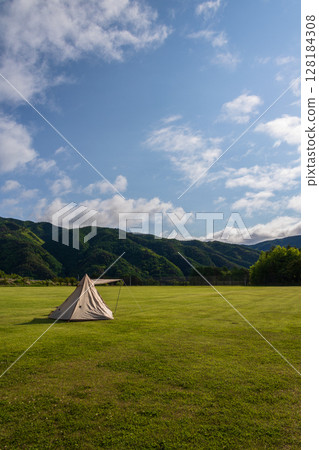 Solo camping in a large campsite on a sunny day Solo camping in a large campsite on a sunny day 128184308
