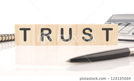 The concept word TRUST is assembled from wooden cubes. Investment based on trust concept The concept word TRUST is assembled from wooden cubes. Investment based on trust concept 128185084