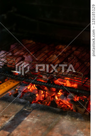 Sizzling Meat on the Grill Over Charcoal, Perfect for a Delicious Outdoor Barbecue Gathering 128185129