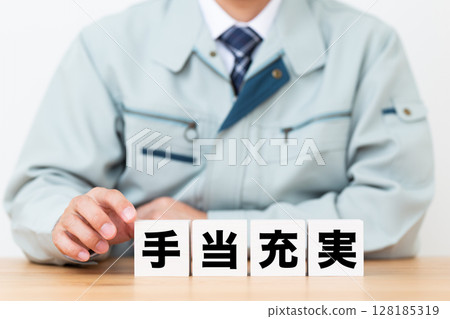 A middle-aged male businessman wearing work clothes and a block with ample allowances A middle-aged male businessman wearing work clothes and a block with ample allowances 128185319