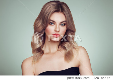 A beautiful young woman with shiny wavy blonde hair A beautiful young woman with shiny wavy blonde hair 128185446