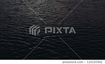 Closeup footage of ocean water surface during dawn 128185982