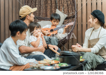 Family eating on a wooden deck (glamping, outdoor, villa, cottage) 128186366
