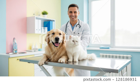 Friendly male veterinarian with a golden retriever and a white cat on an examination table at a vet clinic. 128186931