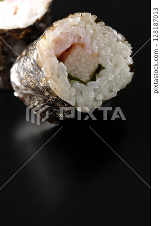 在黑色背景下拍攝的海苔卷,內含梅子、紫蘇和山藥 在黑色背景下拍攝的海苔卷,內含梅子、紫蘇和山藥 128187013