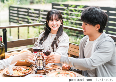 Group of young Asian men and women having a home party glamping on a wooden deck Group of young Asian men and women having a home party glamping on a wooden deck 128187059