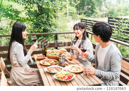 Group of young Asian men and women having a home party glamping on a wooden deck Group of young Asian men and women having a home party glamping on a wooden deck 128187063