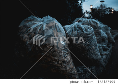 Garbage bag filled with fallen leaves Garbage bag filled with fallen leaves 128187595