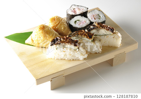 Grilled mackerel, norimaki, and inari sushi photographed on a white background Grilled mackerel, norimaki, and inari sushi photographed on a white background 128187810