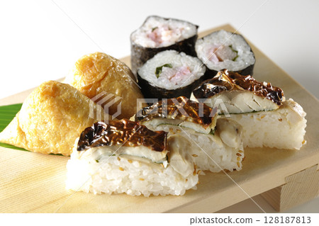 Grilled mackerel, norimaki, and inari sushi photographed on a white background Grilled mackerel, norimaki, and inari sushi photographed on a white background 128187813