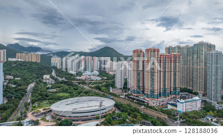 July 1 2025 Densely Built Cityscape Adjacent to Lush Green Forest and Mountain Range 128188036