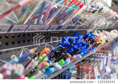 Vibrant multi-colored pens and writing instruments neatly displayed on retail shelves, showcasing a wide variety for school, office, and creative needs Vibrant multi-colored pens and writing instruments neatly displayed on retail shelves, showcasing a wide variety for school, office, and creative needs 128189341