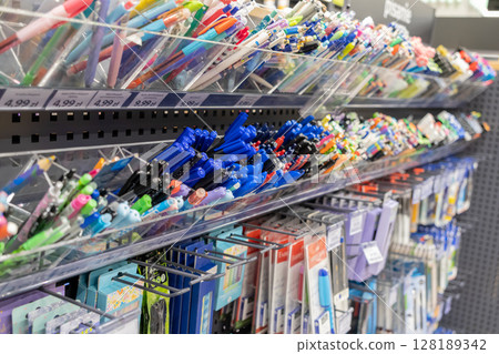 Wide array of colorful pens, pencils, and diverse stationery supplies organized on retail shelves, offering school and office essentials for purchase Wide array of colorful pens, pencils, and diverse stationery supplies organized on retail shelves, offering school and office essentials for purchase 128189342