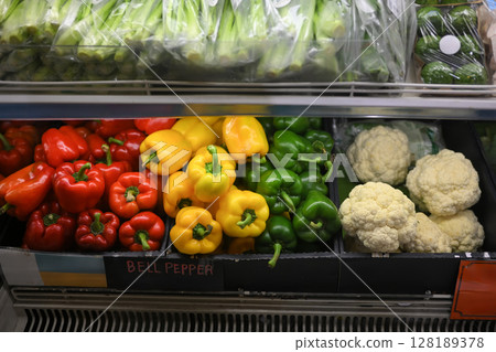 Healthy, vibrant vegetables showcased in a refrigerated supermarket shelf 128189378