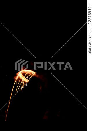 A circle made of flames from hand-held fireworks A circle made of flames from hand-held fireworks 128189544