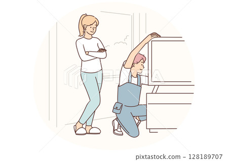 Engineer is repairing television in home of female client who called wizard to help install new TV 128189707