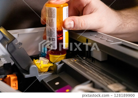 refilling yellow ink tank in printer during maintenance to ensure optimal printing quality refilling yellow ink tank in printer during maintenance to ensure optimal printing quality 128189900